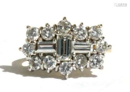 An 18ct gold diamond ring, twelve brilliant cut diamonds surrounding 3 baguette cut diamonds, (2.