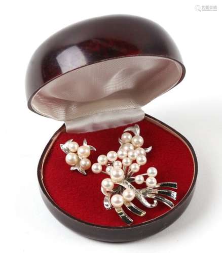 A sterling silver and pearl brooch; together with matching screw back earrings.