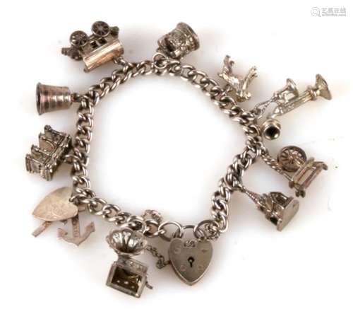 A silver charm bracelet with eleven charms, 48.2g.