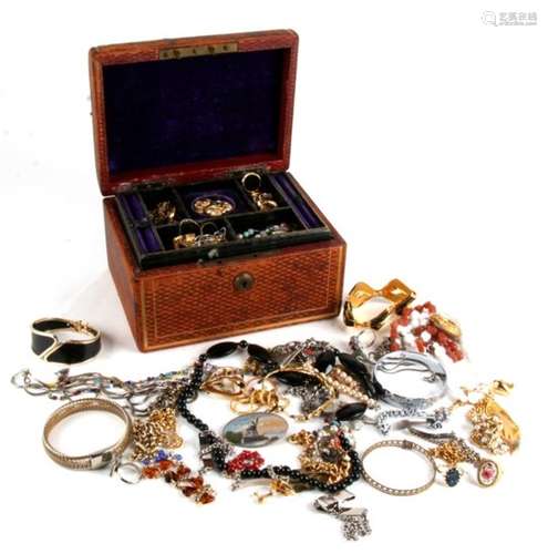 A quantity of costume jewellery in a brown leather jewellery box.