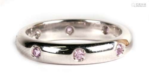 An 18ct white gold and pink topaz full eternity ring, 4.3g. Approx. UK size J.,