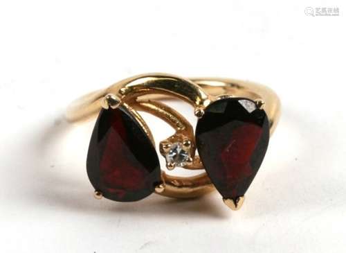 A 14ct gold, diamond & red stone ring, 4.8g. Approx. UK size M.