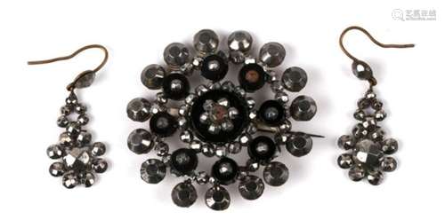 A Victorian cut steel target style circular brooch, together with a pair of cut steel earrings,