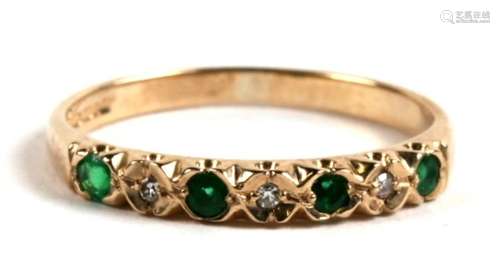 A 9ct gold, emerald and diamond seven stone ring, 1.6g. Approx. UK size M