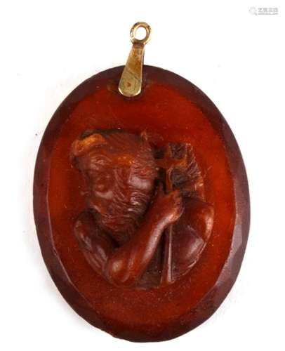 A 19th century facet cut amber pendant carved with a portrait of Neptune. Weighs 14.2g. 5 by 4cm ( 2