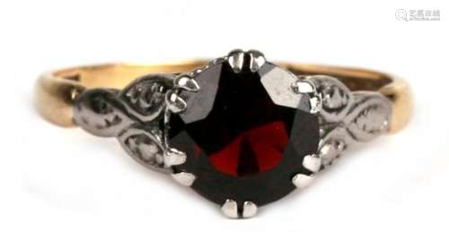 An 18ct gold and platinum ring set with a large garnet, approx UK size 'K'.