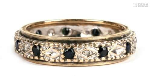 A 9ct gold sapphire and diamond eternity ring, approx UK size 'N'.