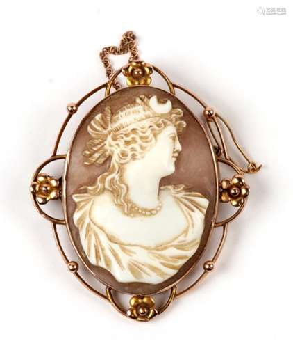 An ornate gold framed shell cameo brooch.