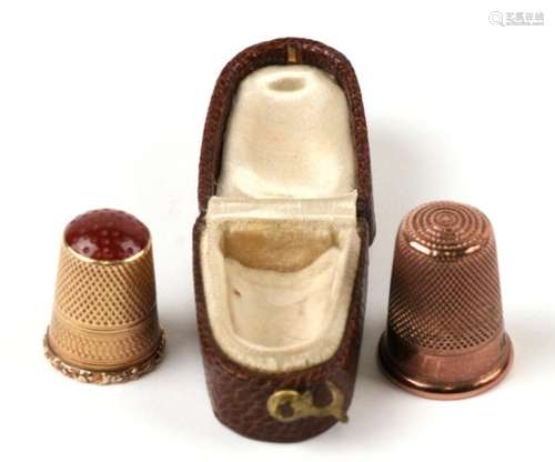 A Charles Horner 9ct gold thimble; together with another in a leather case with carnelian top.