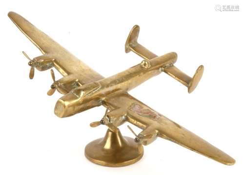 A brass model of a heavy bomber.