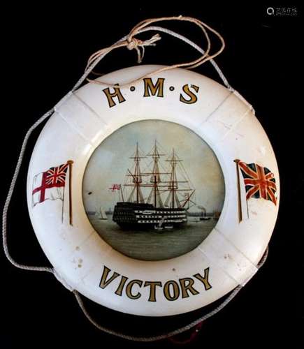 A painted wooden life belt design 'HMS Victory' frame containing an oil on board painting of HMS