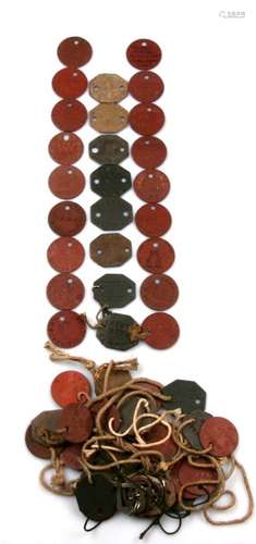 An assortment of WW1 & WW2 fibre board Identity Discs (dog tags). There are 37 different names on