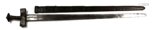 A 19th century Sudanese double edged sword with leather covered hilt and crosspiece in its leather