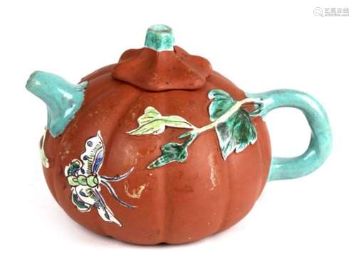 A Chinese Yixing pottery teapot in the form of a melon with enamelled foliage and butterfly