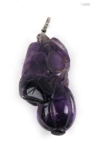 An antique Chinese carved amethyst pendant in the form of a gourd, with a diamond set suspension