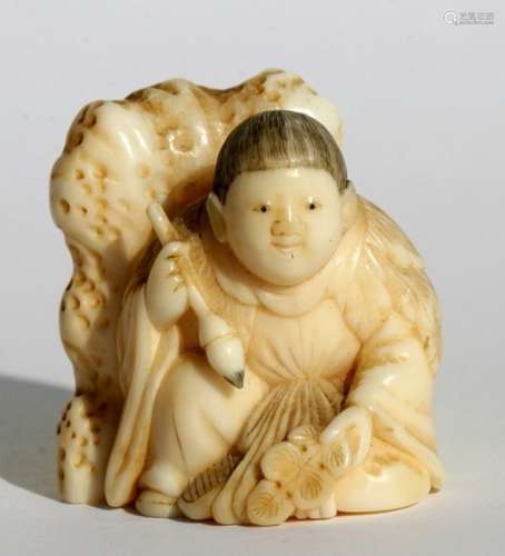 A 19th century Japanese carved ivory netsuke in the form of a boy holding a calligraphy brush, 3.