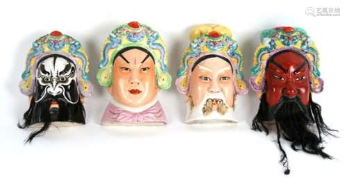 A set of four 20th century Chinese wall appliques in the form of Gods, each 15cms (6ins) high (4).