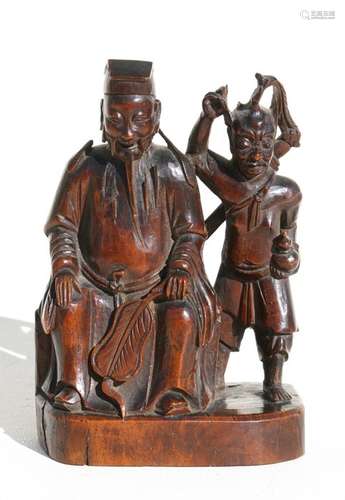 An 18th century Chinese carved hardwood group depicting a seated official and a demon, 16cms (6.