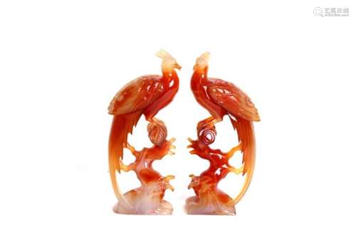 A pair of Chinese figured agate perching birds, 18cms (7ins) high.