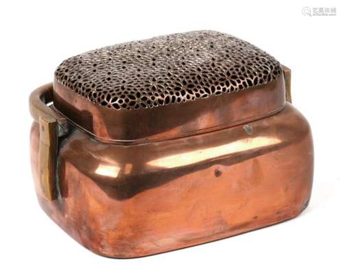 A large Japanese Meiji Period copper hand warmer with brass swing handle and a finely pierced cover.