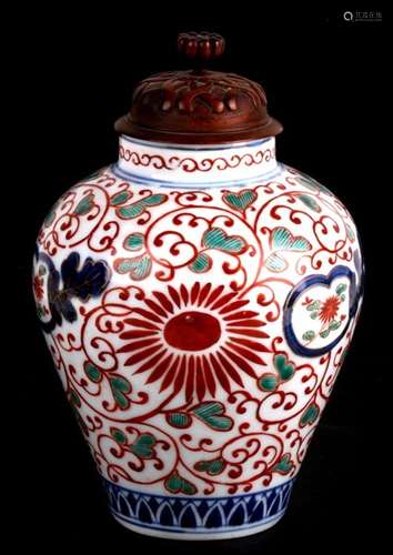 An eighteenth century Japanese Imari jar with later carved wooden lid. The jar is decorated in