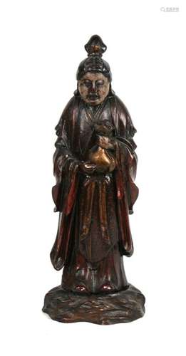 A Chinese lacquered wooden figure depicting a robed man holding a sack, 26cms (10.25ins) high.