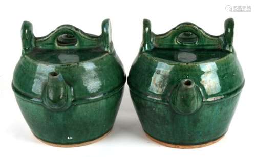 A pair of 19th century Chinese Shiwan green glazed wine pot, 22cms (8.75ins) high.