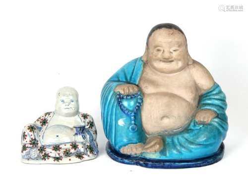 A Chinese pottery figure of a seated Buddha. 26cm 10.25ins high, together with a smaller Buddha.