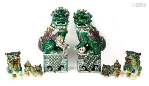 A pair of Chinese Fo Dogs. 35cm (13.75ins) high, together with four smaller examples. (6)