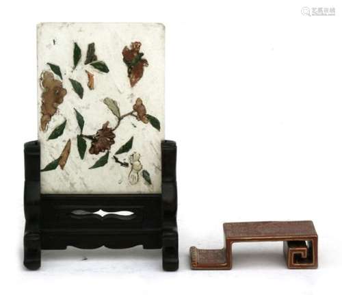 A Chinese jade panel on a hardwood stand, decorated with a butterfly and flowers with applied hard