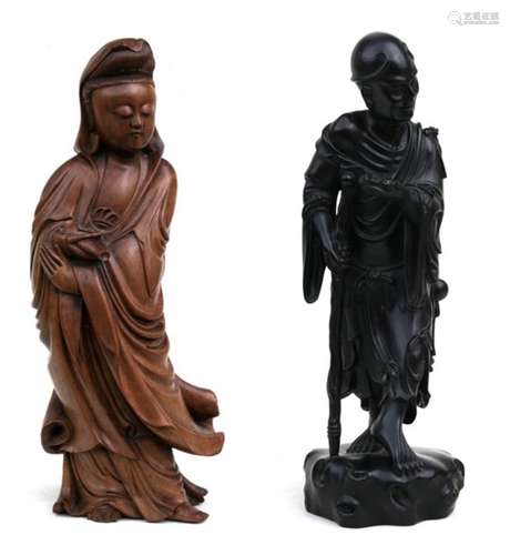 A Chinese boxwood carving in the form of Guanyin holding a vase, 46cms (18ins) high; together with a