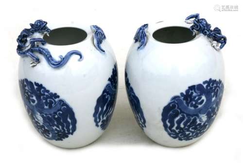 A pair of Chinese blue & white egg shaped vases with applied bat and chilong, four character blue