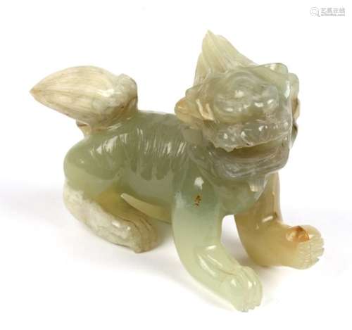 A Chinese jade or hardstone figure of a temple lion, 14cms (5.5ins) long.