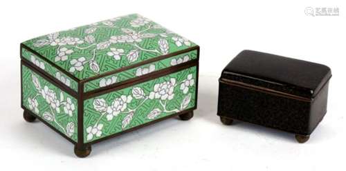 A Chinese cloisonne box decorated with flowers on a green ground, 12cms (4.75ins) wide; together