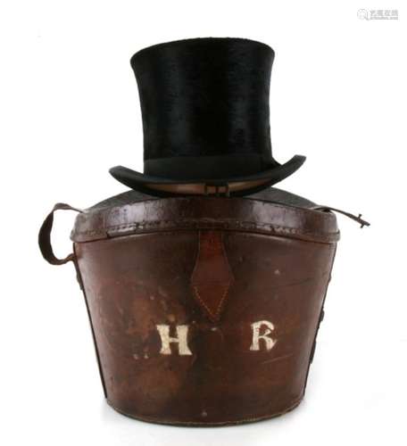 A Hart & Hobbs silk top hat in a leather hat bucket.