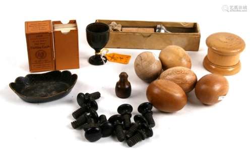 A quantity of turned wooden eggs, ebony cabinet handles, penknives and other items.