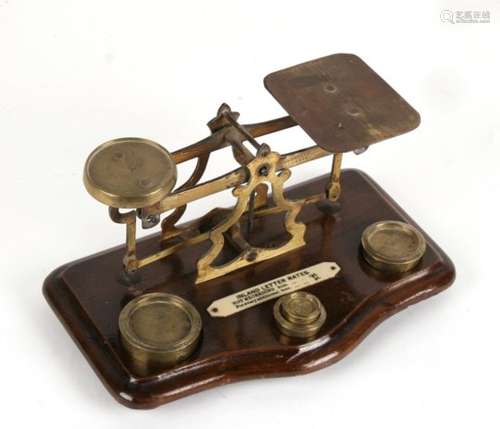 A set of brass postal scales and weights.