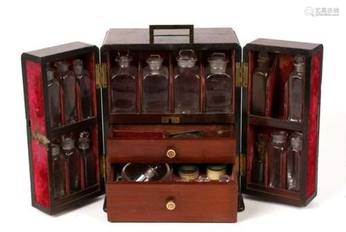 An early 19th century apothecary box, the hinged doors concealing compartments containing glass