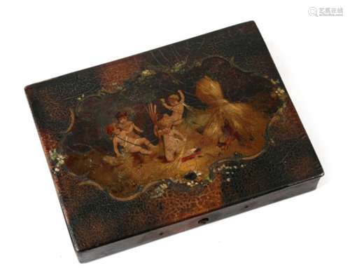 A 19th century lacquered papier mache paint stick box decorated with cherubs, 13cms (5ins) wide.