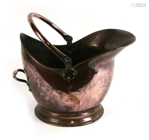 A large copper helmet shaped coal scuttle, together with another