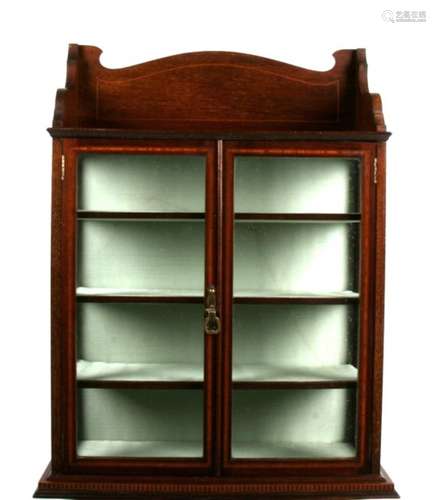 A late 19th century inlaid mahogany glazed wall mounted collector's cabinet, 56cms (22ins) wide.