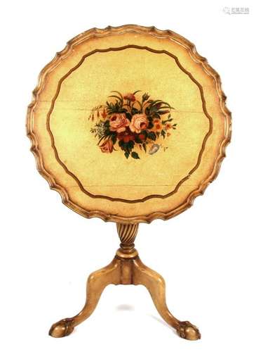 A painted tilt-top occasional table with central floral decoration, on turned column and tripod