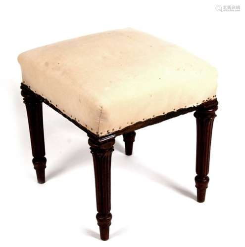 A 19th century mahogany stool on turned legs with upholstered seat.