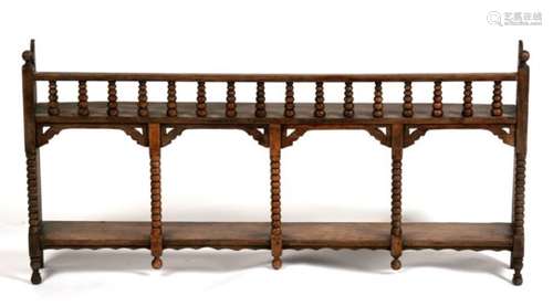 A 19th century walnut wall shelf with bobbin turned supports, 86cms (34ins) wide.