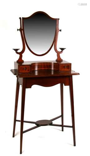 A 19th century mahogany bachelor's dressing stand, the shield shaped mirror above two short drawers,