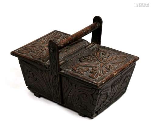 An 18th century carved oak sewing basket with twin opening flaps and carrying handle. 47 by 31 by