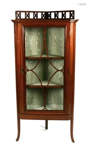 An Edwardian mahogany glazed corner display cabinet, 58cms (26.75ins) wide.