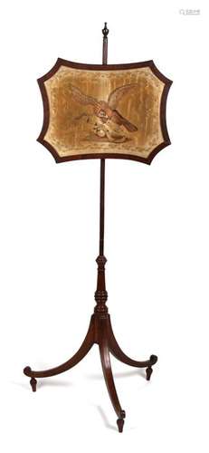 An early 19th century mahogany pole screen, the screen embroidered with an eagle and a snake.