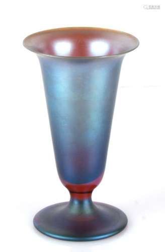 An early 20th century iridescent glass flared trumpet pedestal vase, unmarked but believed to be