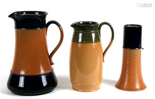 Two Royal Doulton Stoneware jugs, the largest,24cms (9.5ins) high; together with a similar vase,